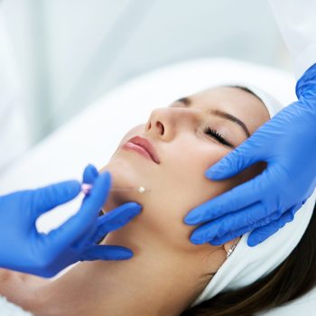 Beautiful young woman getting polydioxanone thread lifting at beauty salon.